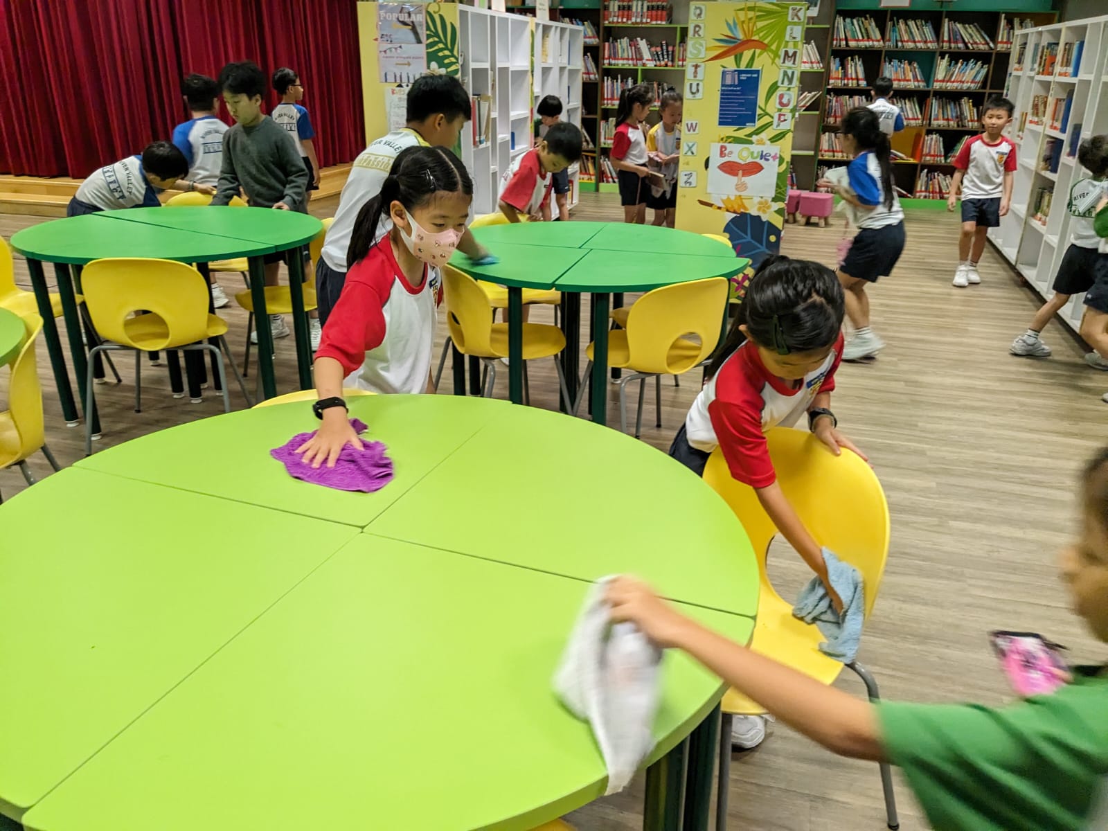 Students assisting in cleaning the library